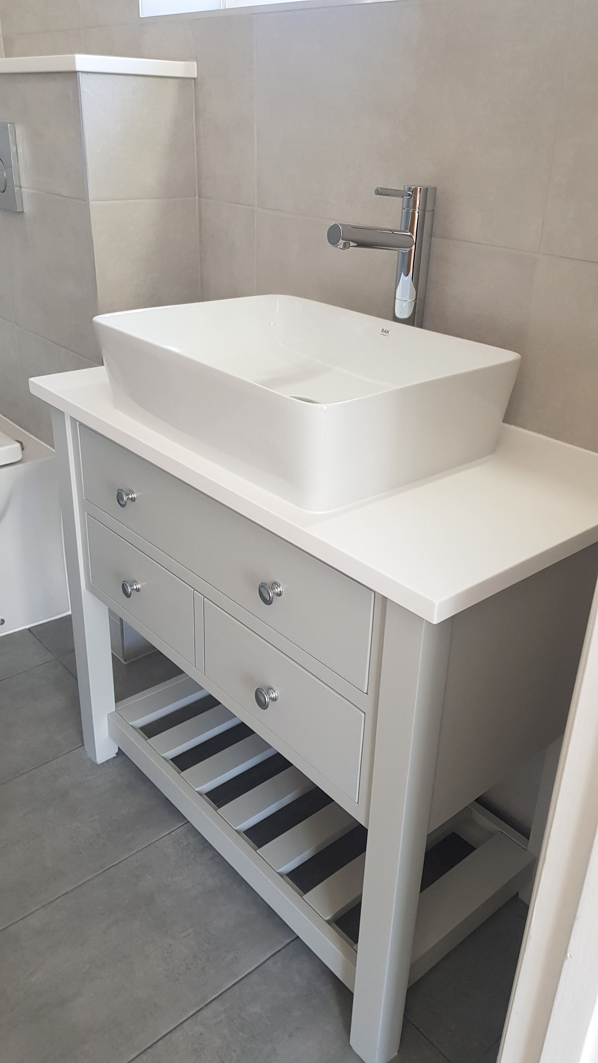 Freestanding vanity unit with a white vessel basin