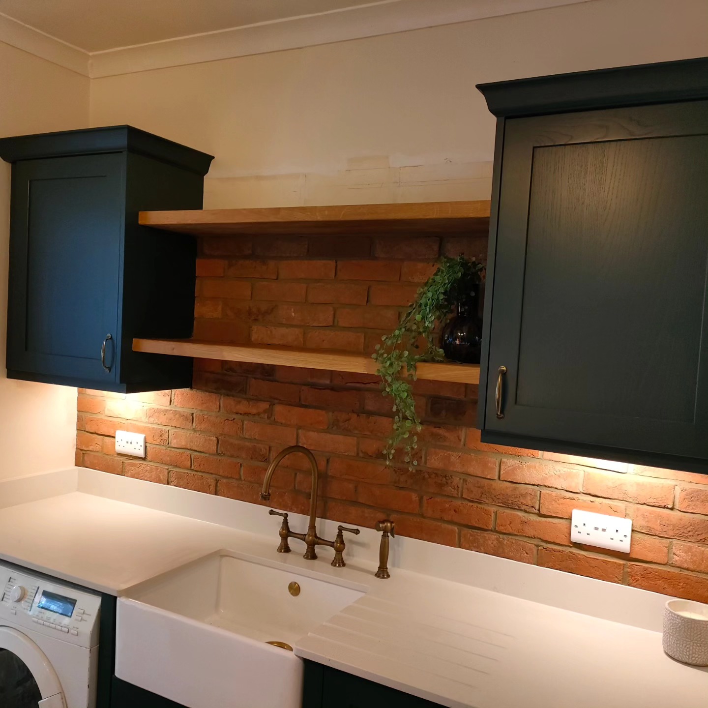 Marine blue shaker kitchen with a Belfast sink and oak shelves