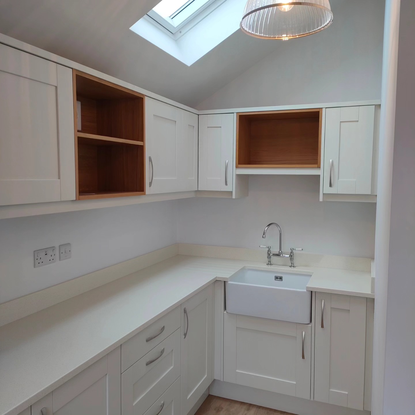 L-shaped hobby room with a Belfast sink under a skylight